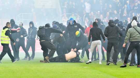 Potýčka medzi fanúšikmi ŠK Slovan Bratislava a FC Spartak Trnava na hracej ploche.