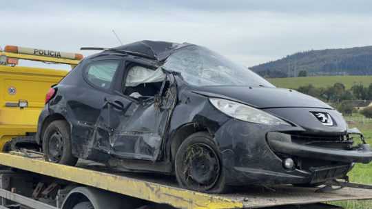 Polícia odťahuje havarované auto.