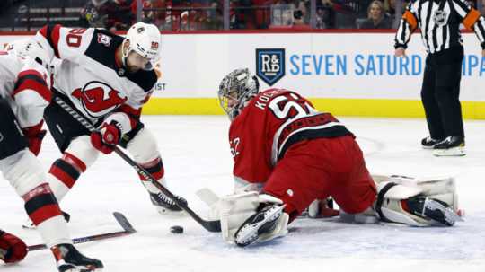 Brankár Caroliny Pjotr Kočetkov blokuje strelu Tomáša Tatara z New Jersey Devils.