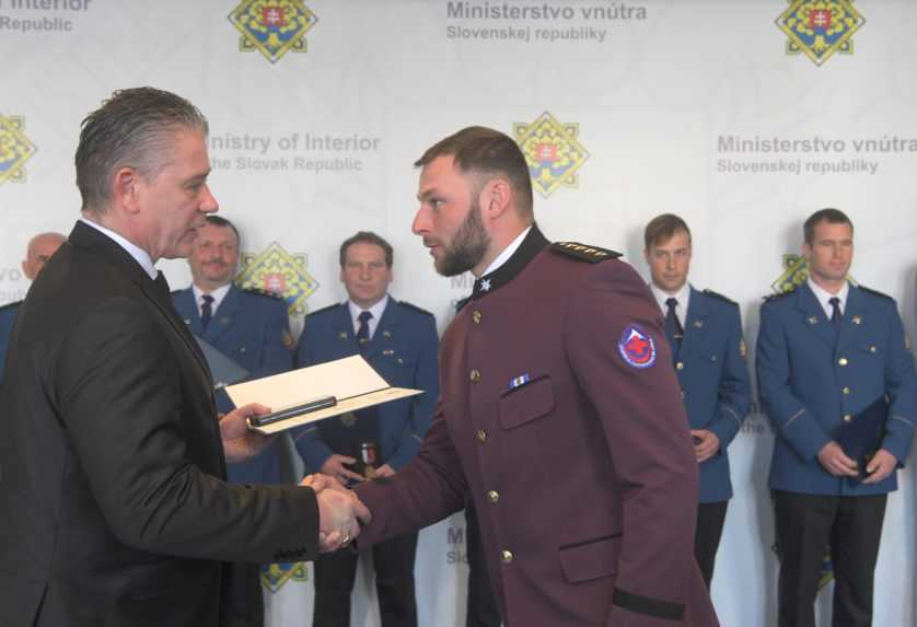 Jeden z členov záchranného tímu si preberá medailu od dočasne povereného ministra vnútra Mikulca.