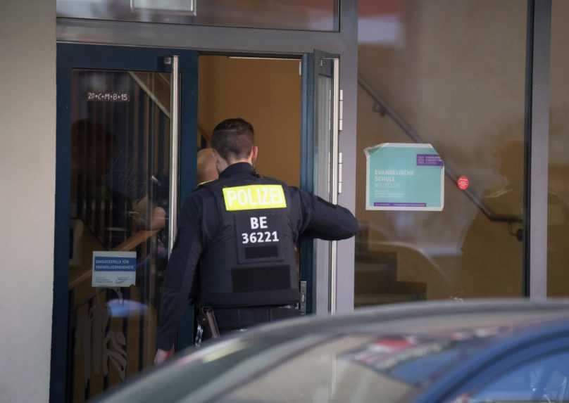 Príslušníci polície vstupujú do školy v Berlíne, na ktorej dvore muž zaútočil na dve školáčky.