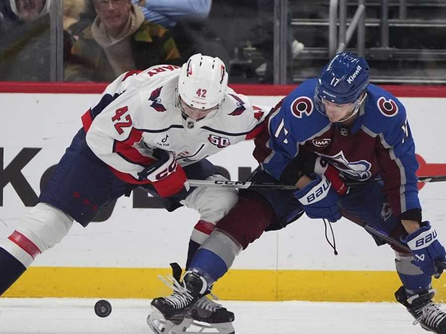 Obranca Washingtonu Capitals Martin Fehervary (vľavo) bojuje o puk s Parkerom Kellym z Colorada.