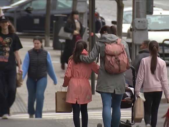 Na ilustračnej snímke matka s deťmi kráčajúca po ulici.