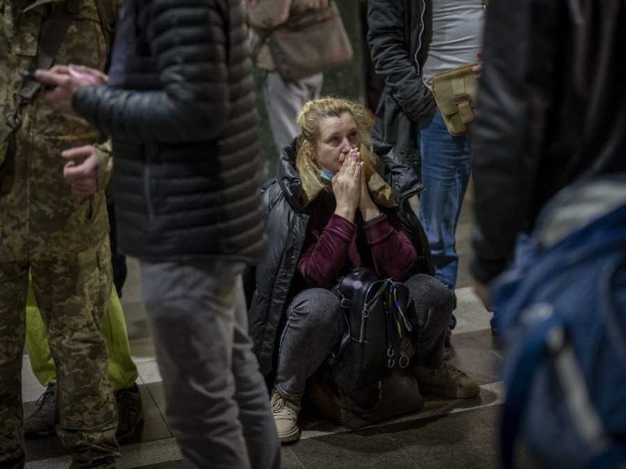 Na archívnej snímke žena čaká na vlak, ktorý sa snaží odísť z Kyjeva na Ukrajine.