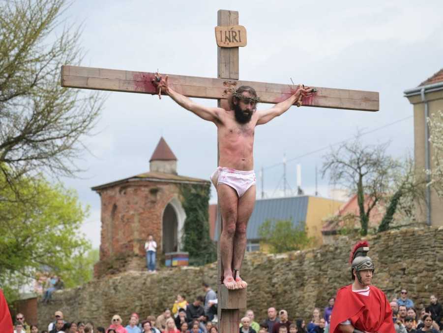 muž stvárňujúci ukrižovaného Ježiša Krista