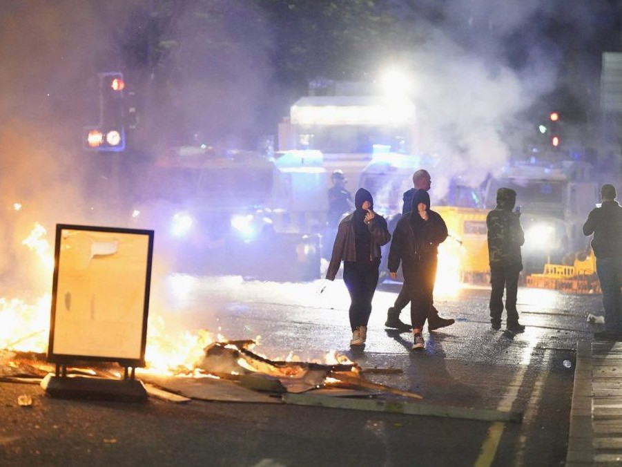 Výtržníci podpaľovali autá, no aj obchody domy a prisťahovalcov.