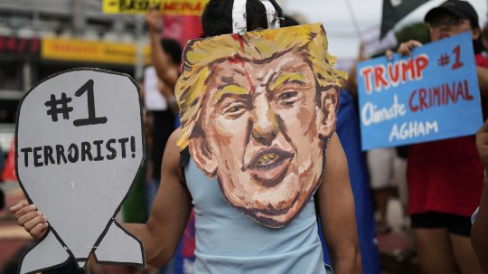 Protestujúci s portrétom amerického prezidenta Donalda Trumpa držia slogany, ktorými odsudzujú nedávne bombardovanie Iránu zo strany USA počas zhromaždenia v meste Quezon na Filipínach.