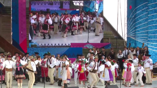 Vystúpenie na festivale Východná, ľudia na pódiu tancujú v tradičných krojoch.