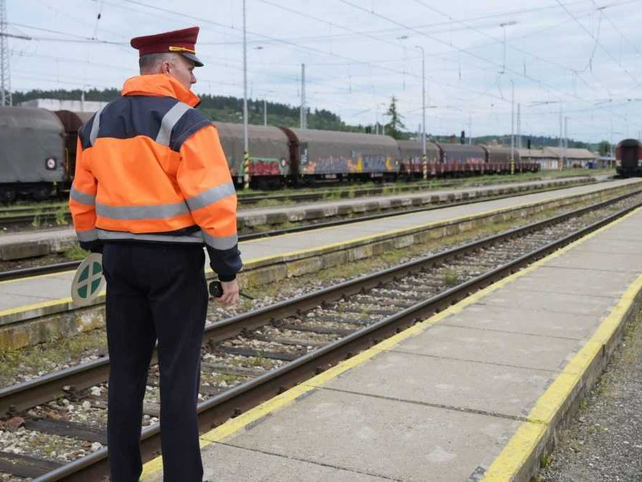 Výpravca sleduje vracajúci sa vlak.