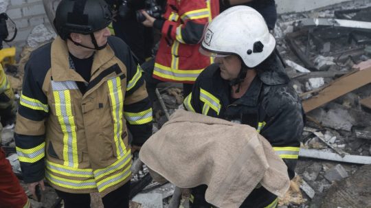 Na snímke záchranár odnáša telo dieťaťa, ktoré prišlo o život pri raketovom útoku ruskej armády na obytnú budovu v ukrajinskom meste Charkov.