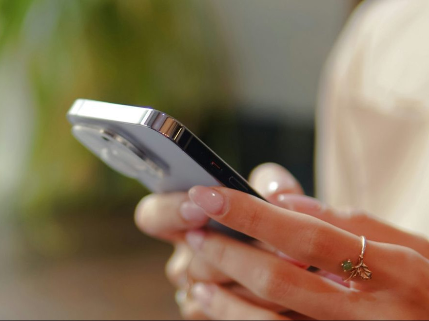 Na snímke žena s telefónom v ruke.