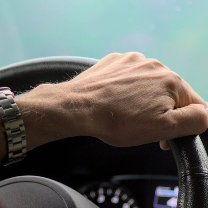 Na ilustračnej snímke ruka seniora na volante.
