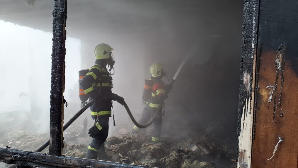 Na snímke hasiči zasahujú pri požiari bývalej stolárskej dielni v Čadci.