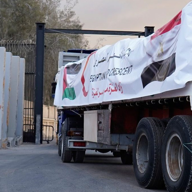 Príslušníci Egyptského Červeného kríža monitorujú kamióny vezúce humanitárnu pomoc.