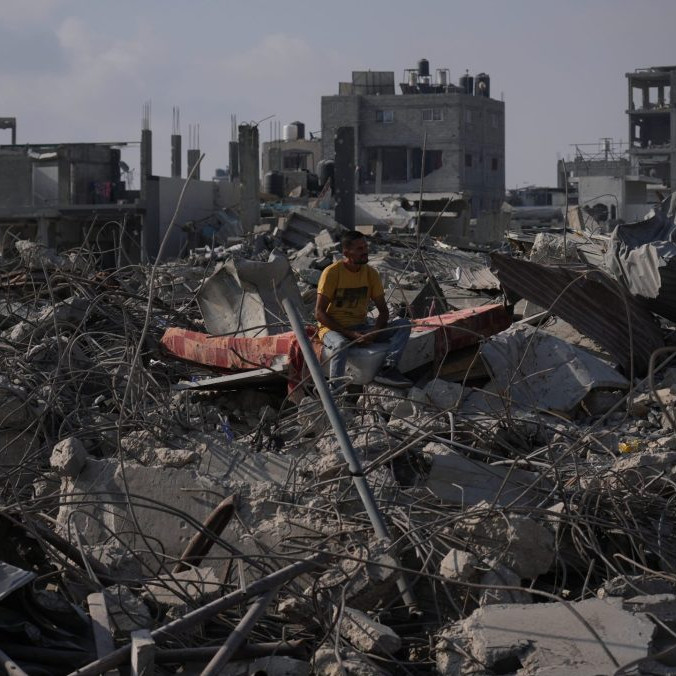 Palestínčan sedí v troskách svojho trojposchodového domu.
