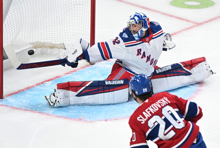 Slovenský hokejista v drese Montrealu Canadiens Juraj Slafkovský (20), ktorý strieľa gól brankárovi New Yorku Rangers Jonathanovi Quickovi.