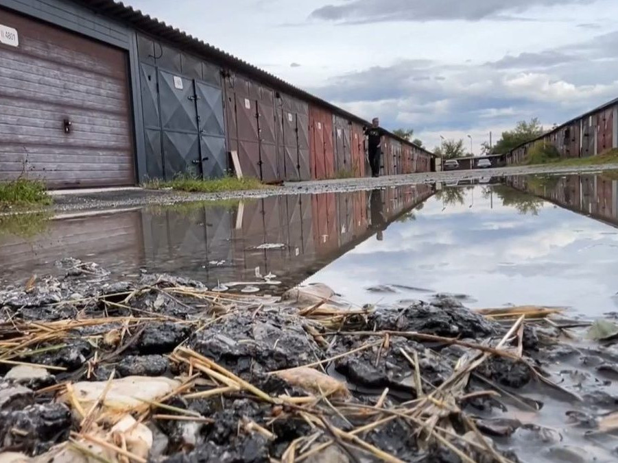 Na snímke prístupová cesta ku garážam plná vody.