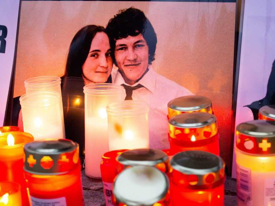 Na snímke fotografia Jána Kuciaka a Martiny Kušnírovej obklopená sviečkami a kahancami.