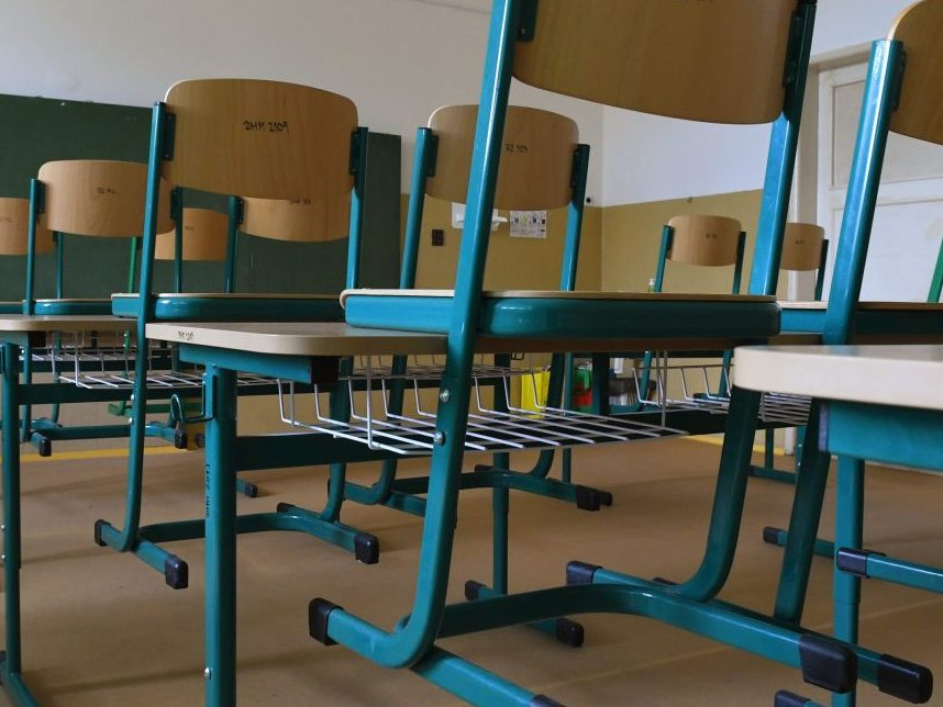 Ilustračná snímka školských lavíc v prázdnej triede.