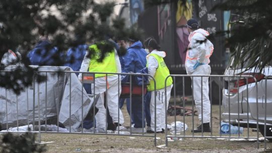 Forenzní technici skúmajú telo jednej z obetí streľby v Sydney.