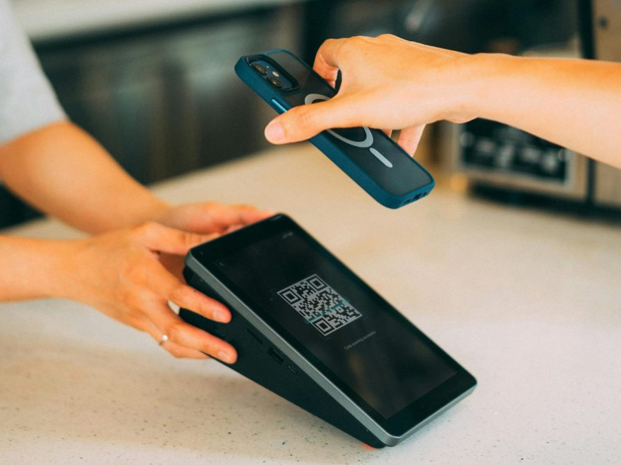 Osoba platí QR kódom.