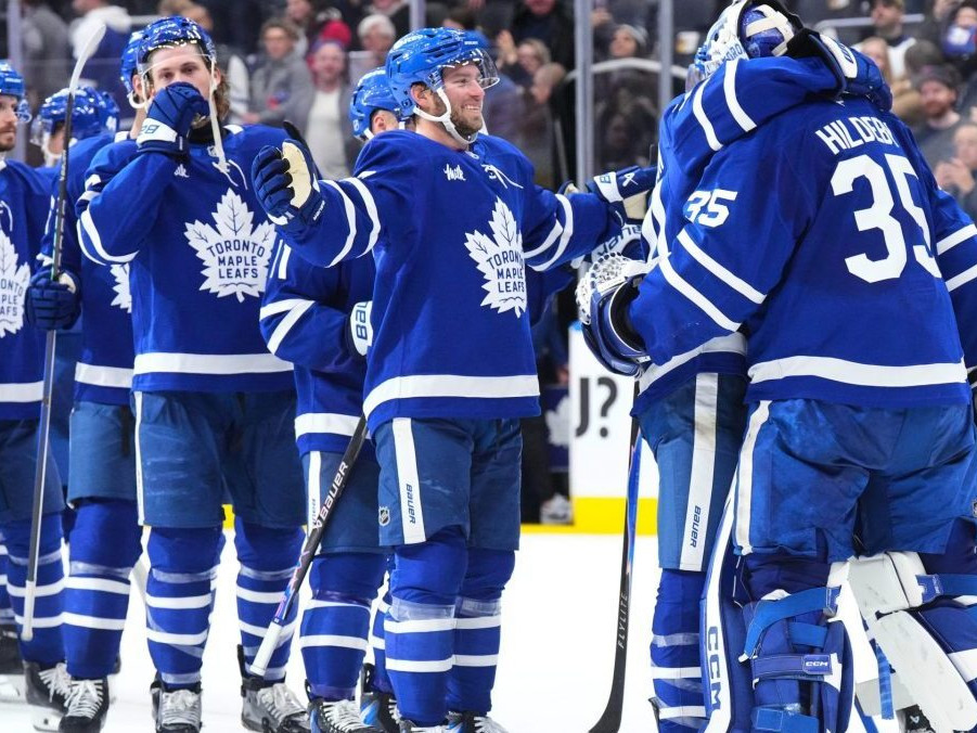 Na snímke brankár Toronta Maple Leafs Dennis Hildeby (vpravo) ktorému gratulujú spoluhráči k čistému kontu.