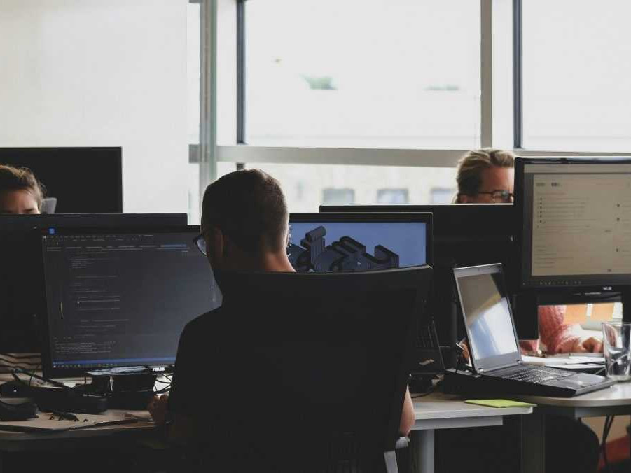 Na ilustračnej snímke muž pracujúci pri počítači.