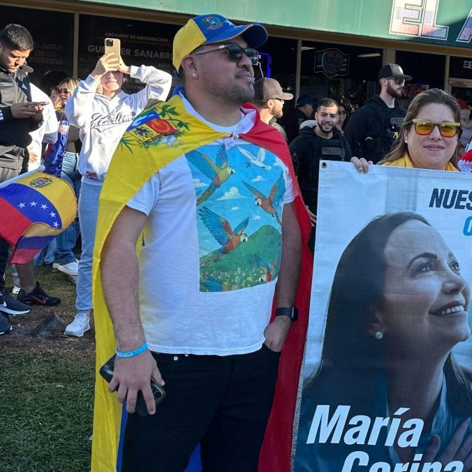 Venezuelčania s transparentom opozičnej líderky a nositeľky Nobelovej ceny za mier.