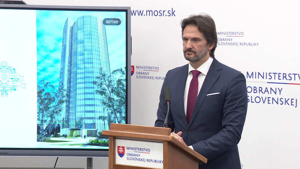 Minister obrany Robert Kaliňák pri obrazovke, na ktorej je budova Kukurice s LED obrazovkou.