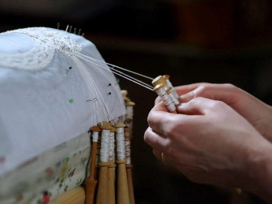 Na snímke výroba paličkovanej čipky.