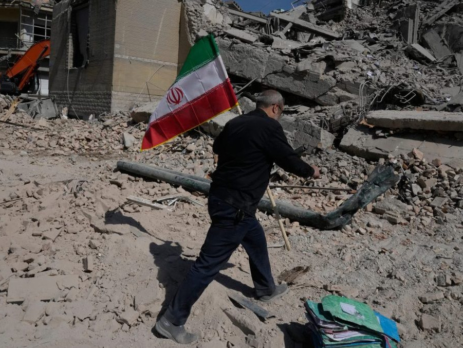 Na snímke muž drží iránsku vlajku po útoku USA a Izraela.