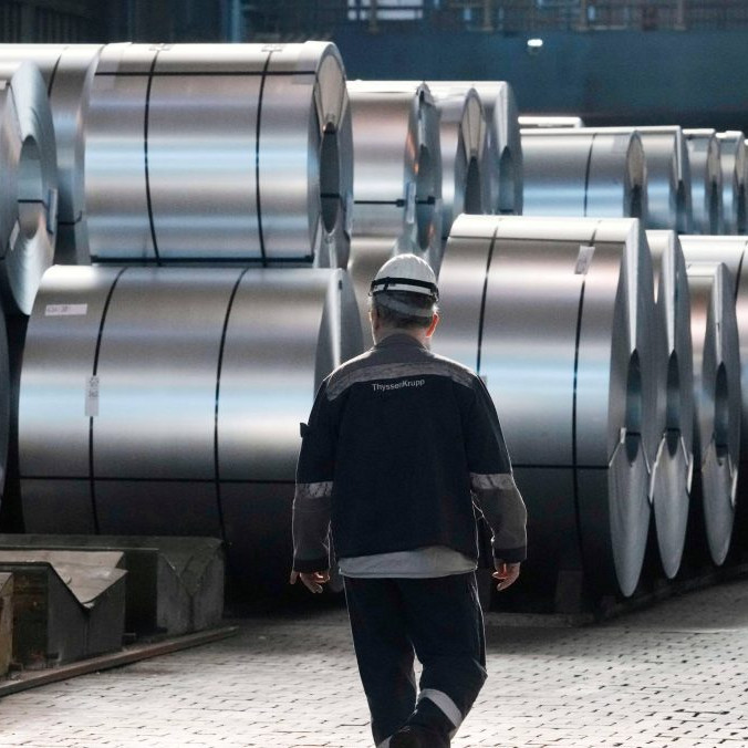 Na ilustračnej snímke oceliar kráča popri oceľových zvitkoch.