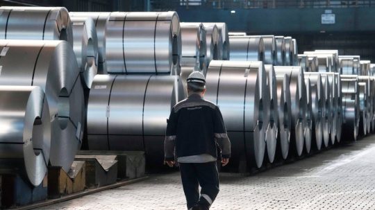 Na ilustračnej snímke oceliar kráča popri oceľových zvitkoch.