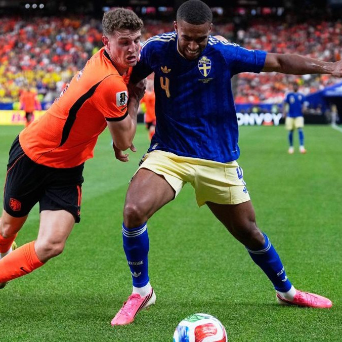 Holanďan Guus Til bojuje o loptu so švédskym futbalistom Isakom Hienom.